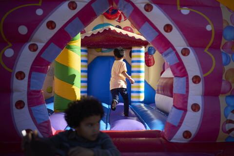 child inside colorful bouncy house