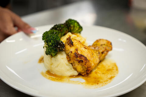 plate of food with grilled chicken, broccoli and mashed potatoes