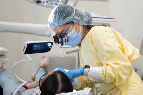 Dentist looking at patient
