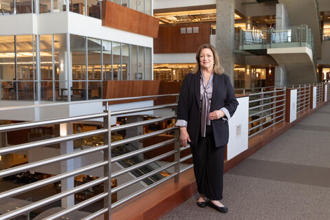 Lorri Jackson stands against railing in Lied Library