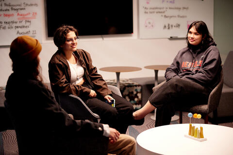 Three people in a room talking