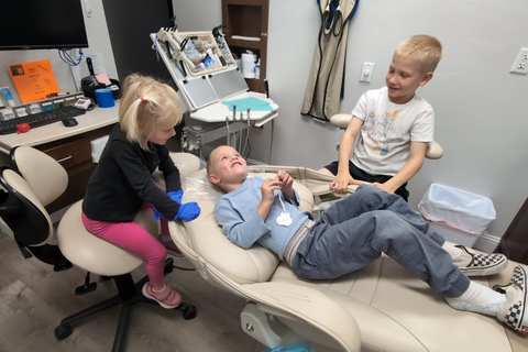three children in dental chair