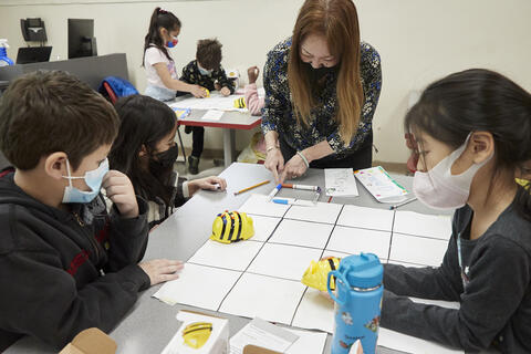Teacher teaching young students