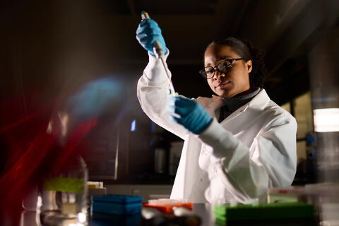 Scientist filling up a tube