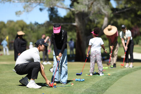 people playing golf on the green
