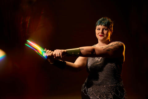 Amber Sewell holding sword and wearing chainmail vest