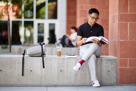 Student sitting on the ledge