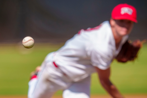 A baseball player in a U-N-L-V uniform pitching