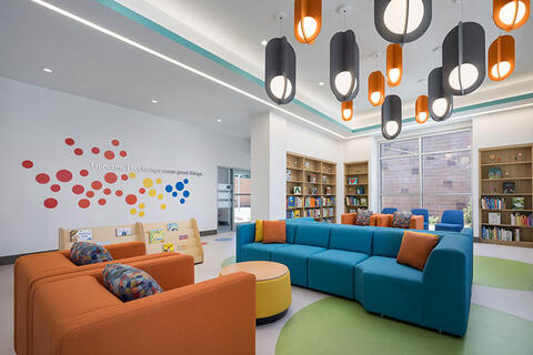 Two couches inside a room with colorful architecture