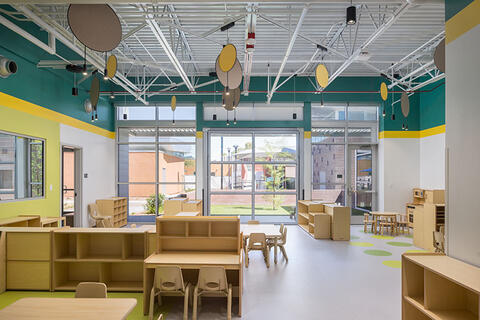 Classroom with wooden furniture and colorful walls