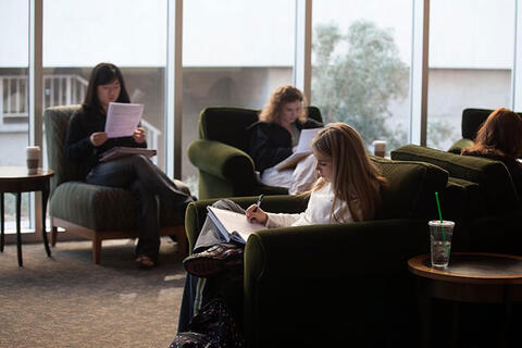 People sitting down and reading their notes.