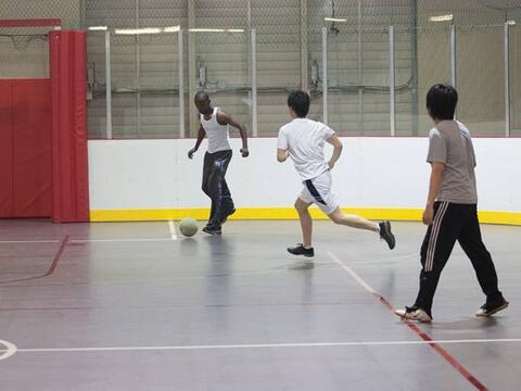 Students playing indoor soccer at an court in the SRWC.