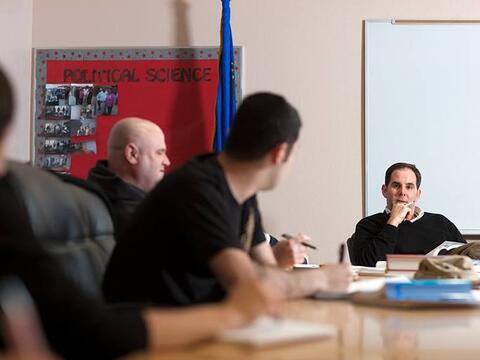 Students discussing political science during a graduate seminar.