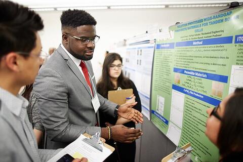 Students discussing a research poster