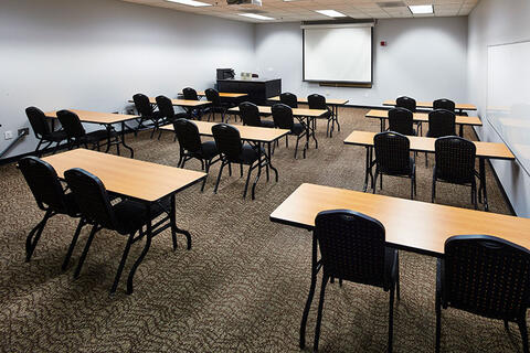 Small classroom with a few tables and chairs