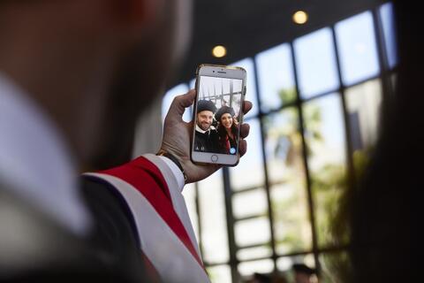 Graduate taking selfie
