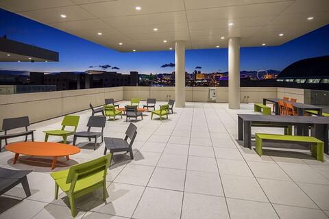 Outdoor terrace with various multi-colored tables and chairs