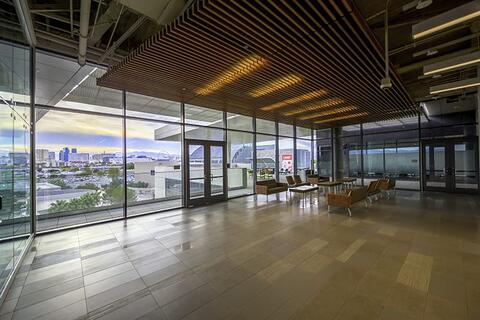Open lounge area with floor to ceiling windows that overlook the Las Vegas Strip