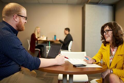 A man and woman looking over a document together.