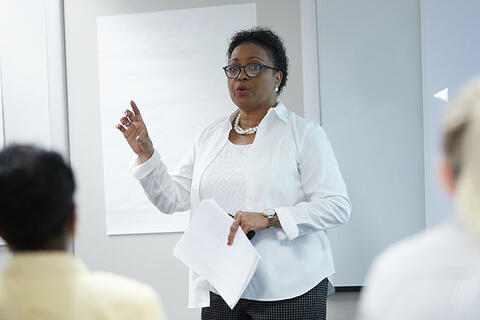 An educator giving a lecture to other educators.