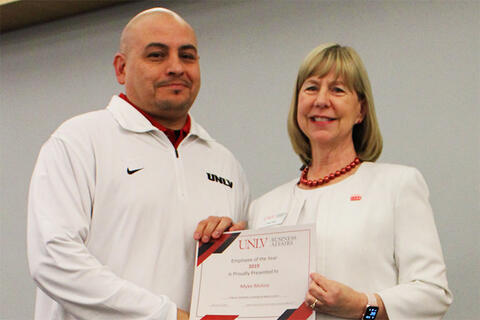 Employee receiving a certificate of recognition award.