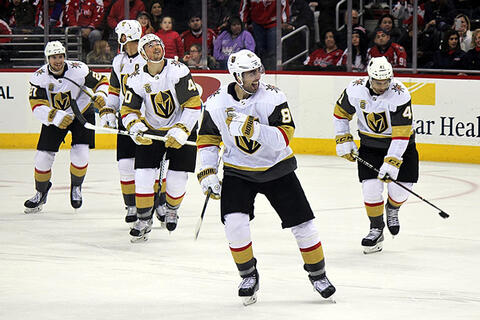 Alex Tuch of the Las Vegas Golden Knights skating on the ice with his teammates behind