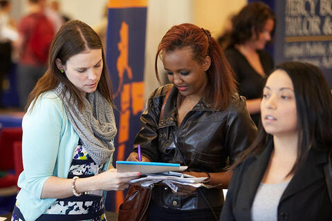 Two women looking over some documents.