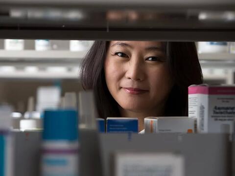 A woman looking through a medicine shelf