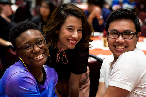 Three honors students smile for the camera