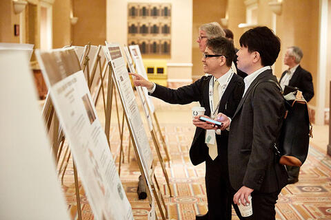 Attendees looking at different posters