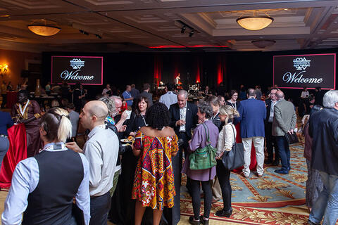 Many attendees enjoying the conference's opening reception