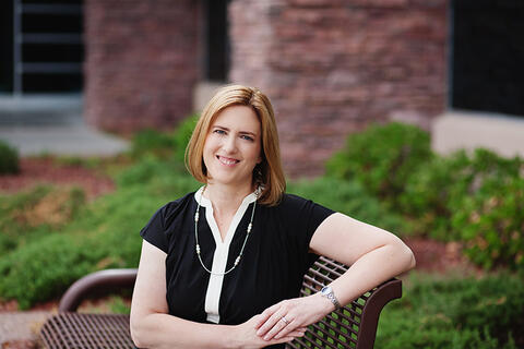 A woman in a blue and white blouse