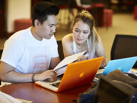 Two students looking at their notes