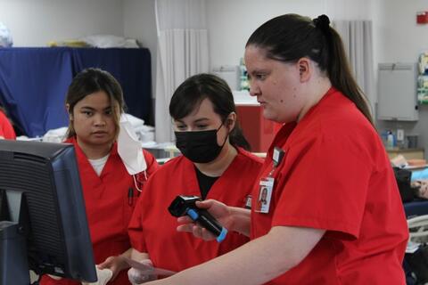 Nursing students looking at monitor