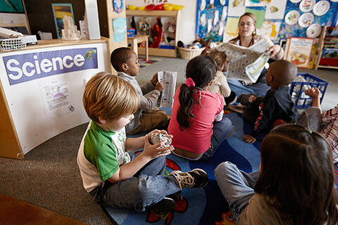 children listen to a science lesson at school
