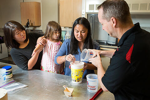 Taking measurements of 4-year-old Hailey Dawson