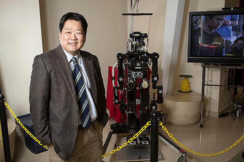 Paul Oh with a robot