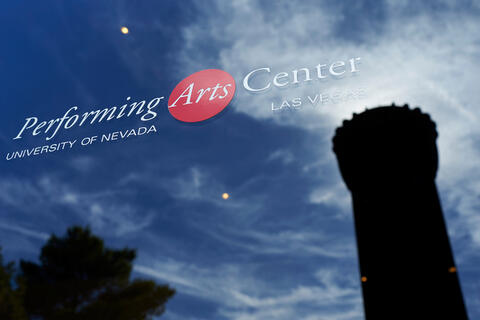 UNLV's "Flashlight" is reflected in the window of the Performing Arts Center