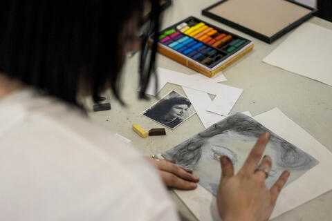 woman drawing with a portrait