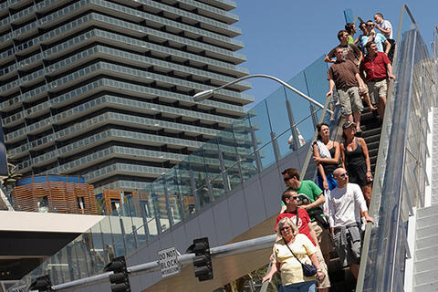People riding outside escalator