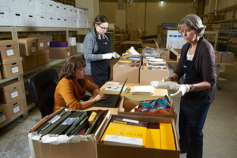 UNLV librarians sort through a collection of historical images from the Culinary Workers Union Local 226