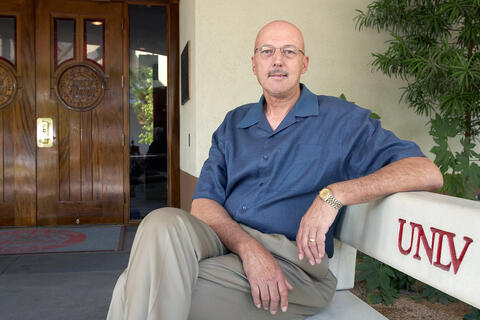 Fred Albrecht, sitting on bench outside the Richard Tam Alumni Center