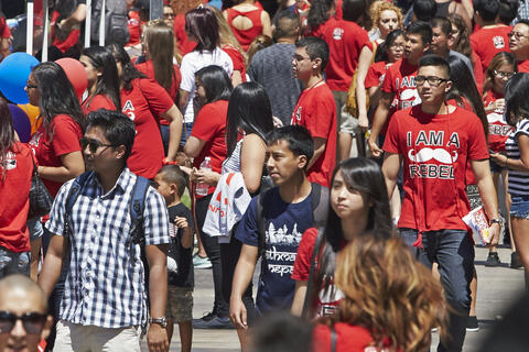 crowd of students walk outside