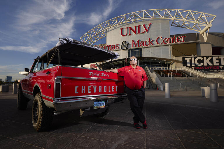 President Keith E. Whitfield posing with the Rebel Ride, his 1969 Chevy Blazer.