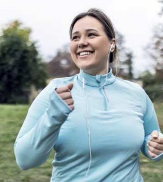 A woman jogging and listening to music