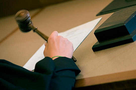 Hand holding a gavel