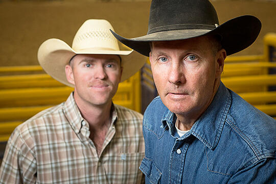 Two men with cowboy hats and polo shirts