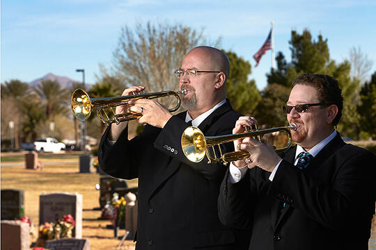 Gary Cordell and Larry Ransom play trumpet at a funeral