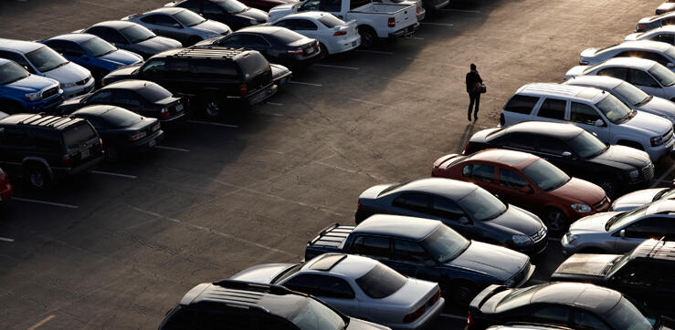 Student walking through a parking lot