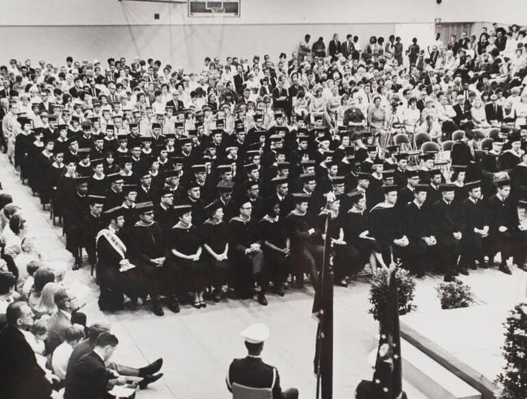 Students wait to receive their diplomas